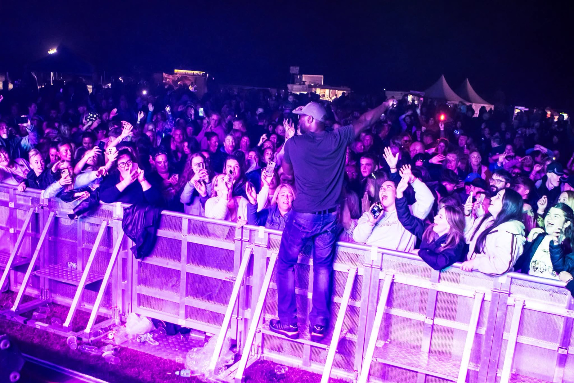 Jay Kurdy on the barrier fronting a packed festival crowd
